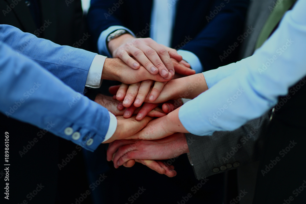 Close-up of business partners making pile of hands at meeting. Close-up of business partners making pile of hands at meeting.