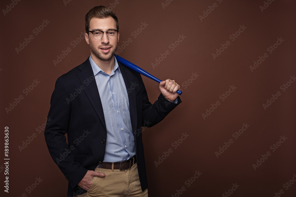 Portrait of cheerful male in modern suit keeping small bat in hand. Sport and career concept. Isolated and copy space Portrait of cheerful male in modern suit keeping small bat in hand. Sport and career concept. Isolated and copy space