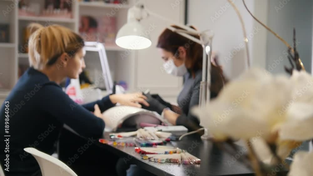Beauty salon - professional manicure for attractive young woman Beauty salon - professional manicure for attractive young woman
