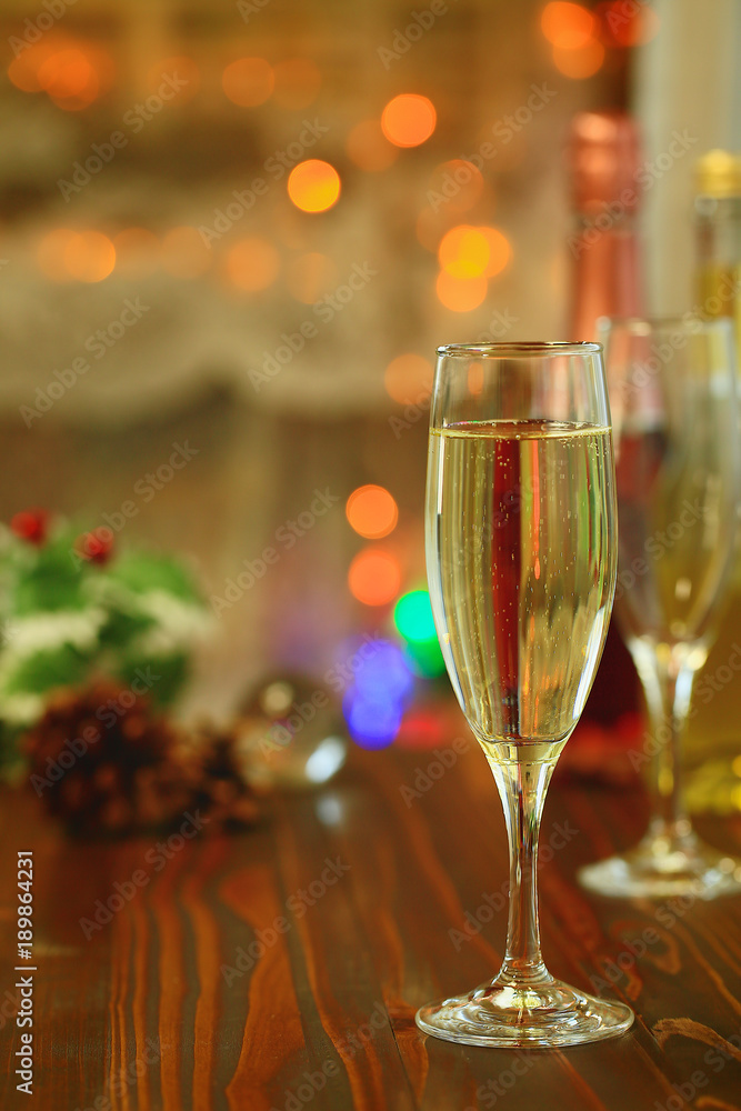 Two glasses of Sparkling wine in front of defocused colorful lights, evening warm tone background.