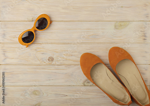 Women's ballet flats and sunglasses are orange color.