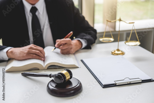 Judge gavel with Justice lawyers, Businessman in suit or lawyer working on a documents. Legal law, advice and justice concept