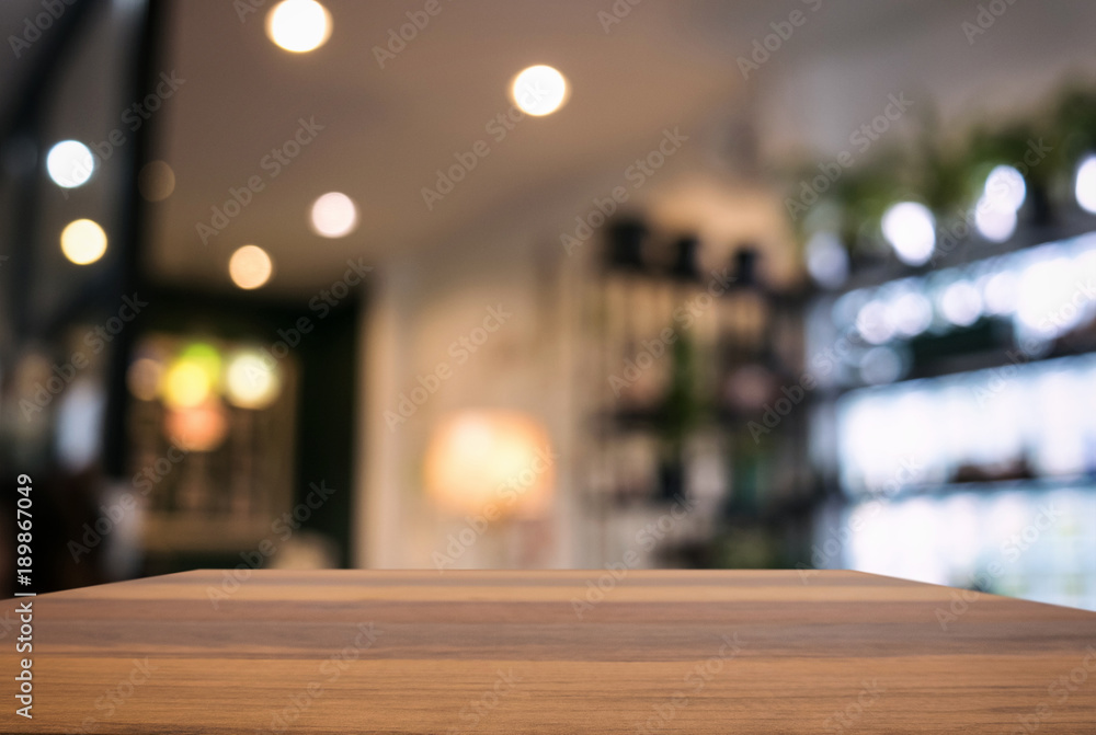 Empty wooden table and blurred background of abstract in front of restaurant or coffee shop for display of product or for montage