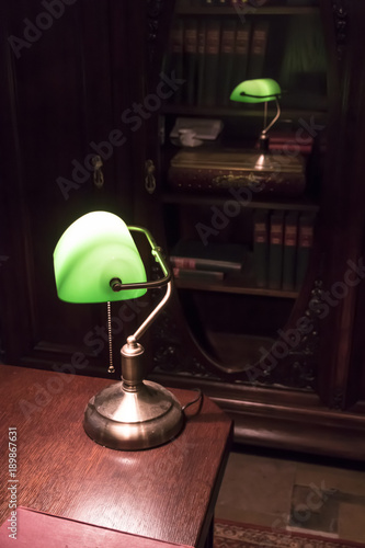 Classical lamp on the desk in old stylish office.