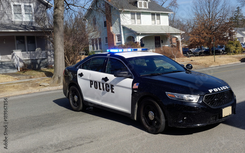  Police car barricade on residential neighborhood street.