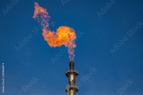 Flare of a coking plant with blue sky