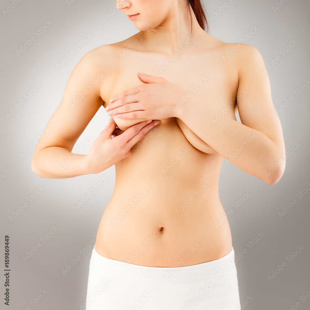 Woman examining breast isolated on white background Woman examining breast isolated on white background
