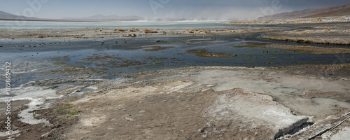 Laguna y Termas de Polques hot spring pool with Salar de Chalviri in background, Salar de Uyuni, Potosi, Bolivia - South America photo