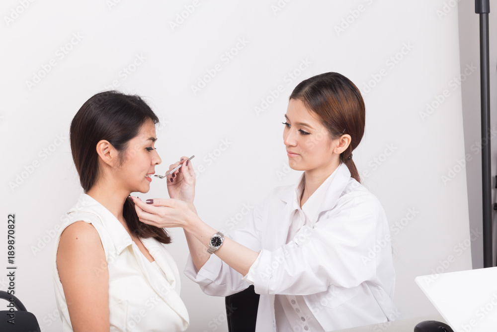 Female doctor checking a patient's teeth. Female doctor checking a patient's teeth.