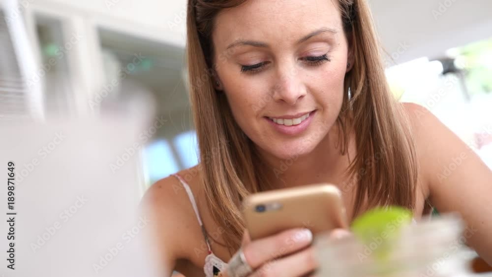 Young woman connected with smartphone in bar Young woman connected with smartphone in bar