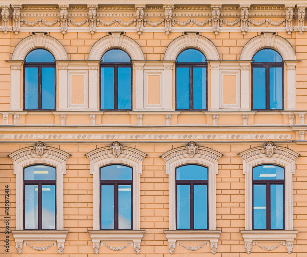 Obraz premium Several windows in a row on the facade of the urban historic building front view, Saint Petersburg, Russia 
