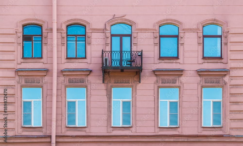 Several windows in a row and balcony on the facade of the urban historic building front view, Saint Petersburg, Russia
Several windows in a row and balcony on the facade of the urban historic building front view, Saint Petersburg, Russia