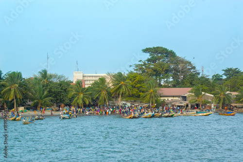 African people on the shoreline of Banjul, Gambia photo