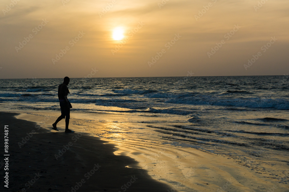 A man silhoutted on Kotu Beach, Gambia