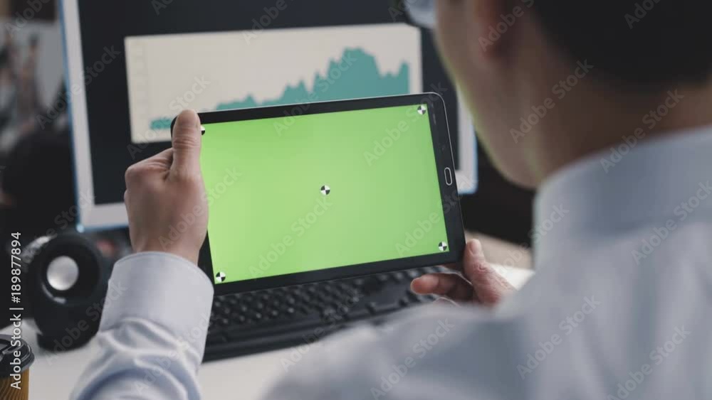 A man using a tablet PC with a green screen in front of camera. 4K A man using a tablet PC with a green screen in front of camera. 4K
