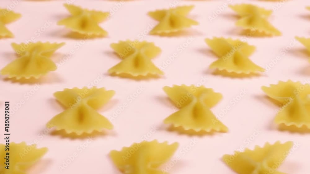 Pasta on pink pastel surface close up macro. Pasta on pink pastel surface close up macro.