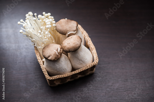 Mushroom in The basket weave on wood background.