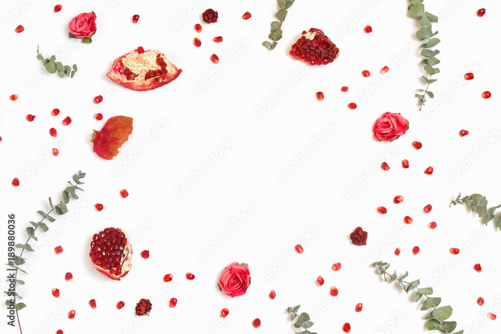 Stylish background with pomegranate and eucalyptus branches, white background, copyspace Stylish background with pomegranate and eucalyptus branches, white background, copyspace