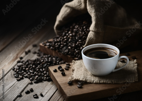 coffee cups and coffee beans on a wooden table photo