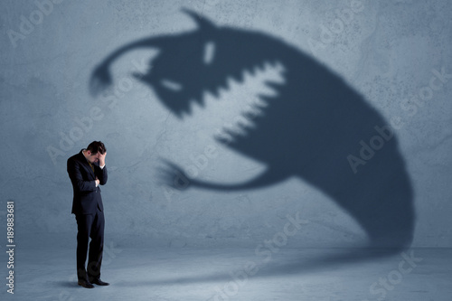 Fényképezés Business man afraid of his own shadow monster concept