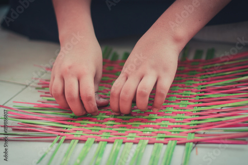 Closeup to hand of Thai students grade 4 in primary school are weaving pattern thai.