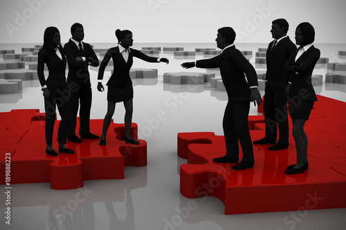 Merger of two teams on a jigsaw puzzle.
Two teams of successful executives merging on a jigsaw puzzle showing a partnership.