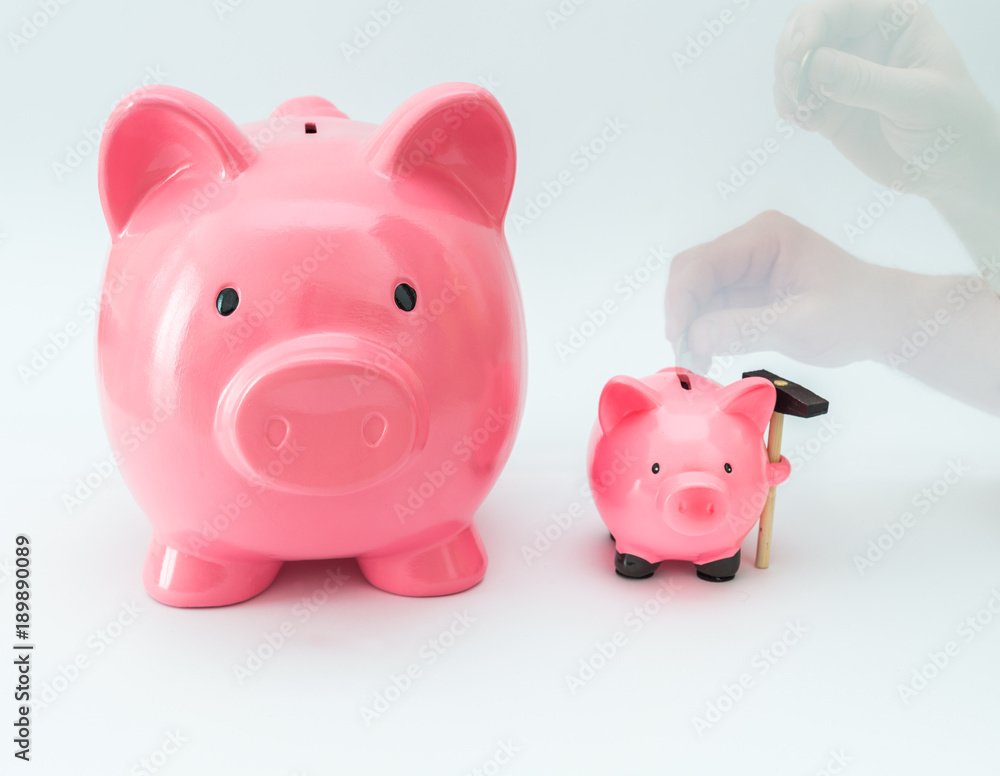 Big and little piggy moneybox as a saving concept. Big and little piggy moneybox as a saving concept.