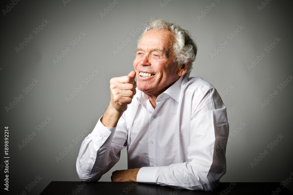 Old man in white is smiling. Old man in white is smiling.