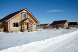 Group of wooden houses at winter, sunny day