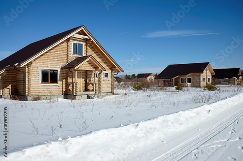 Group of wooden houses at winter, sunny day