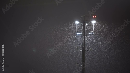 Snowstorm at the airport. Workers and service cars work near aircraft photo