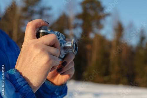 Outdoor amateur photography concept, vintage camera in hands