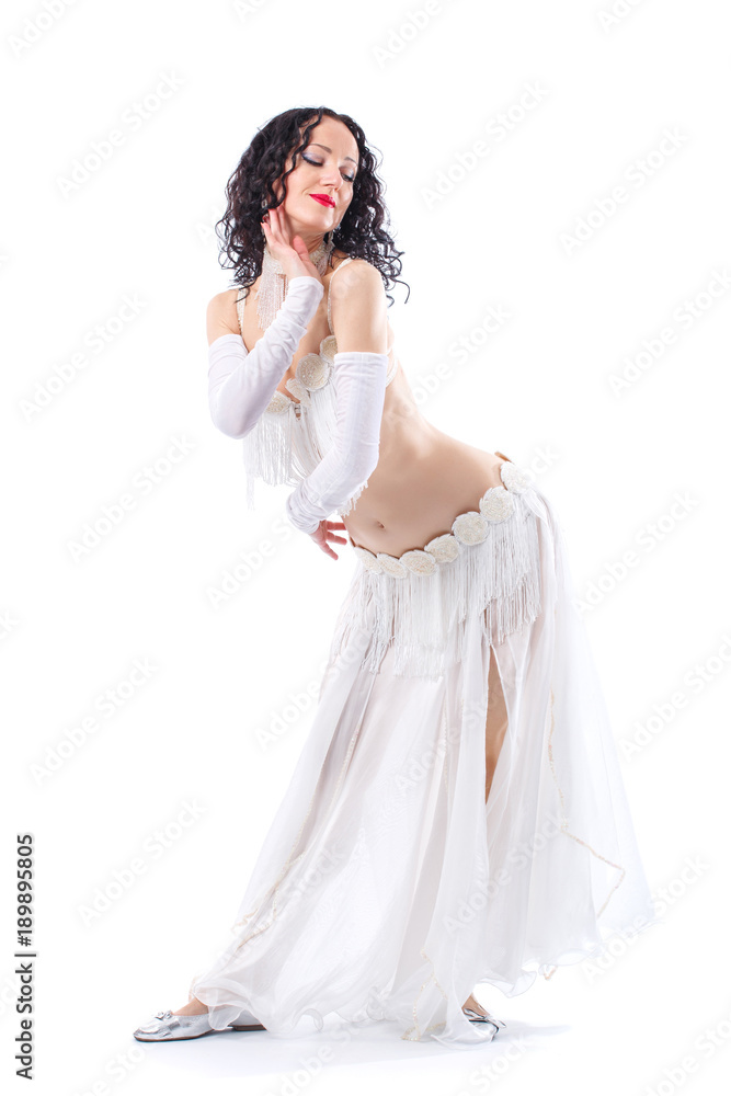 Arabian bellydancer sexy woman in white costume on white background. Oriental beauty model in studio portrait.