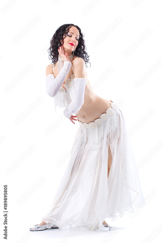 Arabian bellydancer sexy woman in white costume on white background. Oriental beauty model in studio portrait. Arabian bellydancer sexy woman in white costume on white background. Oriental beauty model in studio portrait.
