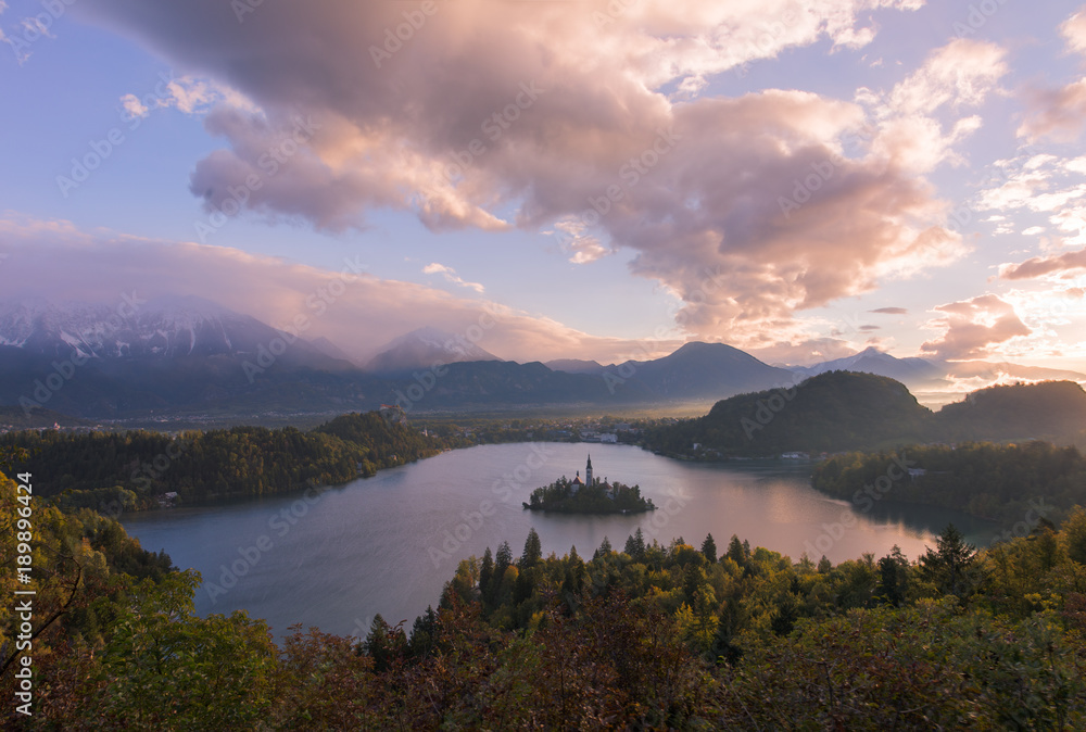 Sun rising over Lake Bled. The sun created a cotton candy colored sky at Lake Bled on a calm morning. Made for a dream like setting.