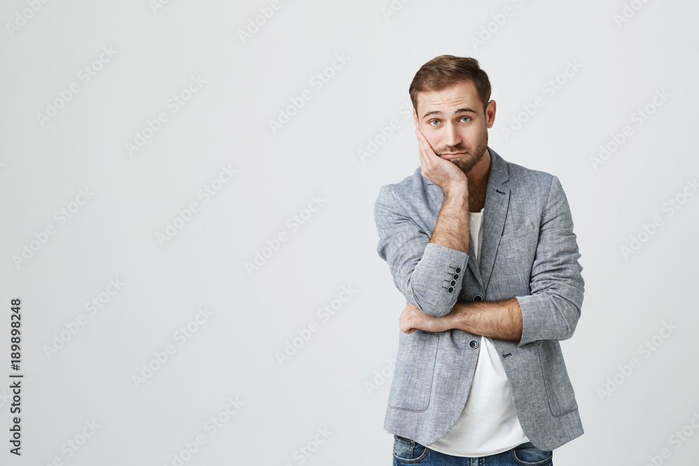 Horizontal portrait of handsome male adult with beard, keeps hand under chin, looks confidently, listens to someone`s official speech, analyzes information or makes decision. People and lifestyle Horizontal portrait of handsome male adult with beard, keeps hand under chin, looks confidently, listens to someone`s official speech, analyzes information or makes decision. People and lifestyle