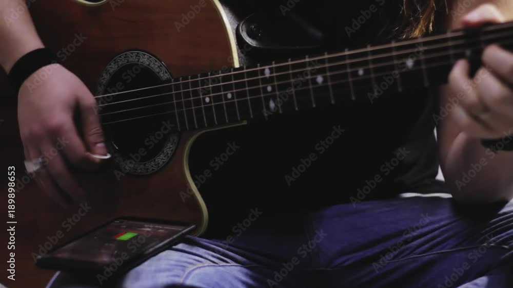 musician play on electro acoustic guitar in studio musician play on electro acoustic guitar in studio