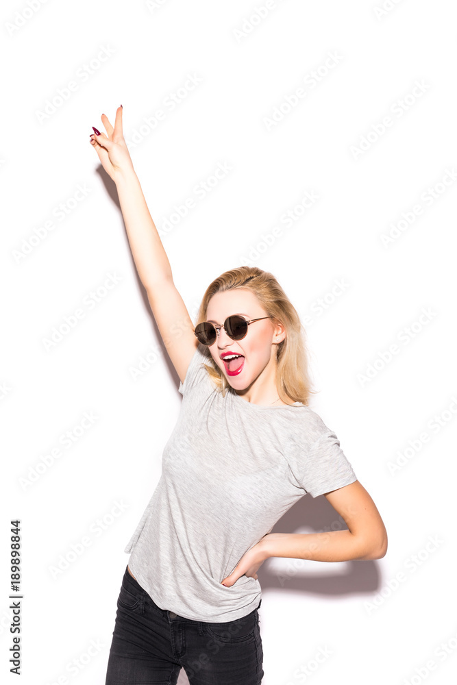Stylish fashion blonde bad girl in a t-shirt and rock sunglasses dangerous rocky emotional woman on white background Stylish fashion blonde bad girl in a t-shirt and rock sunglasses dangerous rocky emotional woman on white background