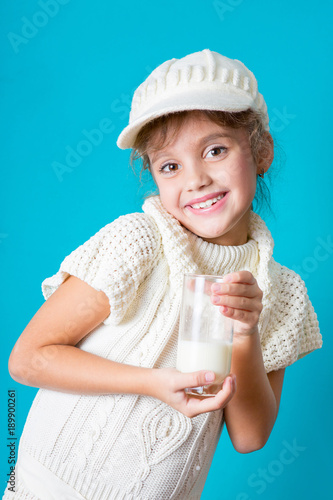 Beautiful little girl with glass of milk