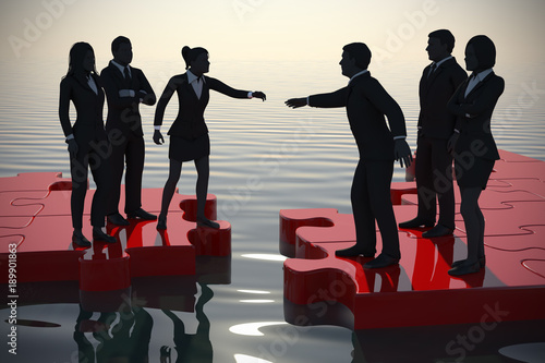Merger of two teams on a jigsaw puzzle at sunset.
Two teams of successful executives merging on a jigsaw puzzle at sunset showing a partnership.