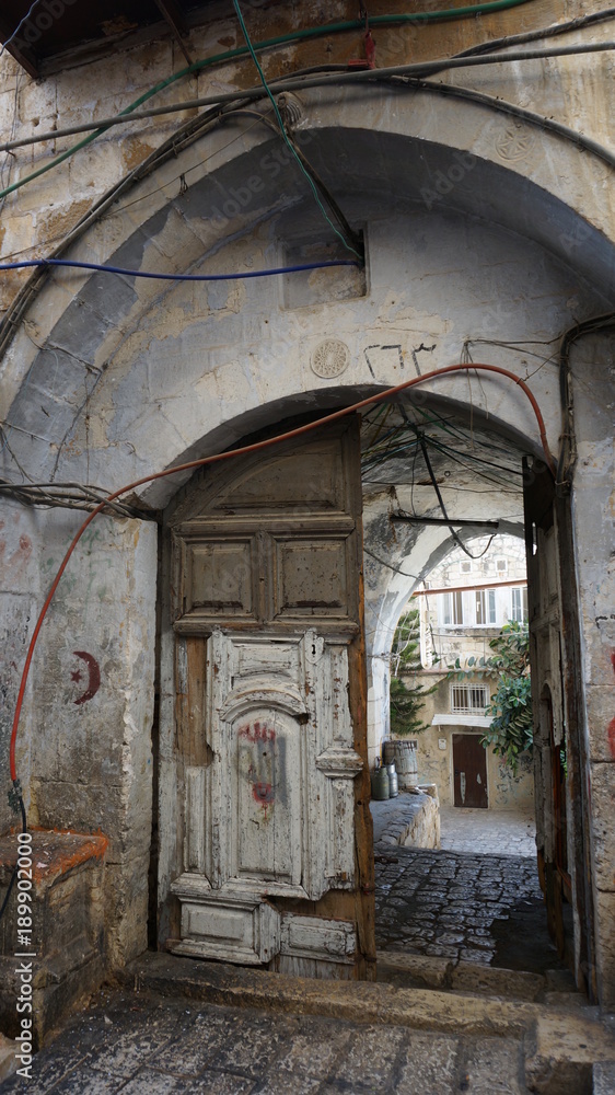 Ancient stone archway with wiring and cables