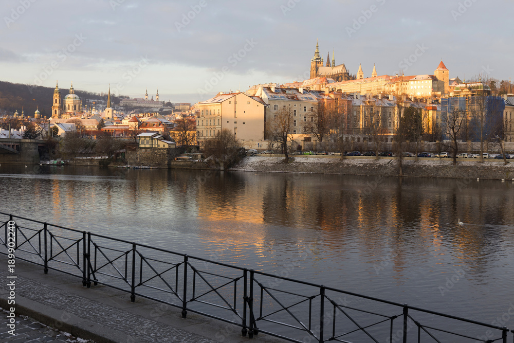 Snowy Prague Lesser Town with gothic Castle in the rising sun, Czech republic