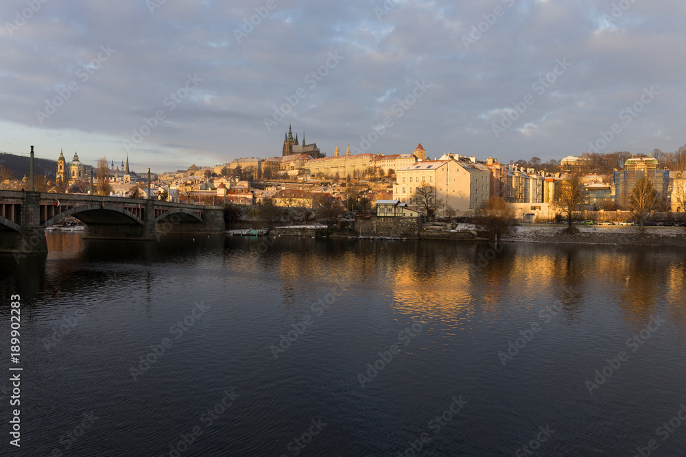 Snowy Prague Lesser Town with gothic Castle in the rising sun, Czech republic