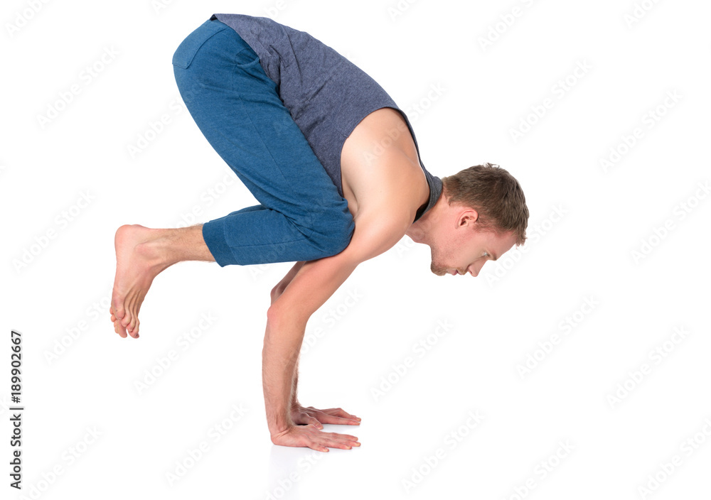 Adult man with naked torso doing exercise on white background