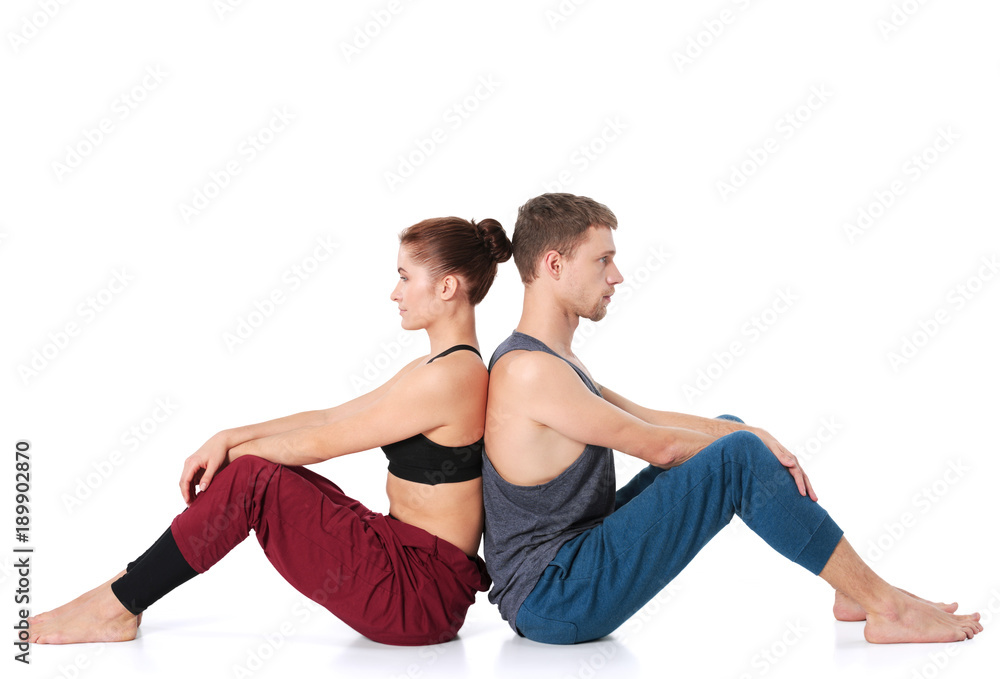 Young athletic couple practicing acroyoga. Balancing in pair Young athletic couple practicing acroyoga. Balancing in pair
