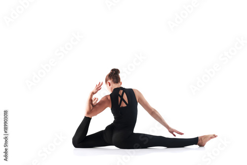 Sporty young woman doing yoga practice isolated on white background - concept of healthy life