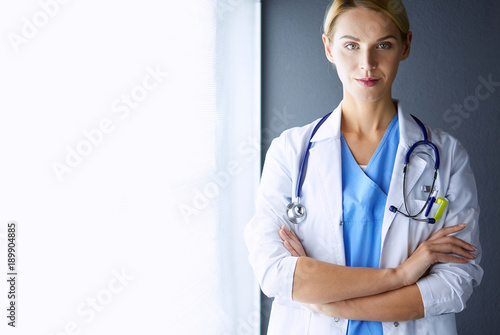Photography Portrait of young woman doctor with white coat standing in hospital