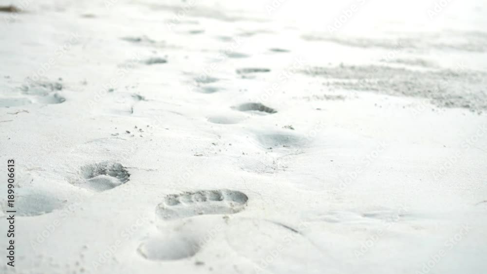 close up of footprints on the white beach. close up of footprints on the white beach.