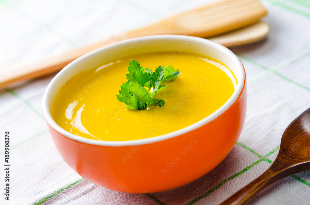 Pumpkin soup served on the table in bowl Pumpkin soup served on the table in bowl