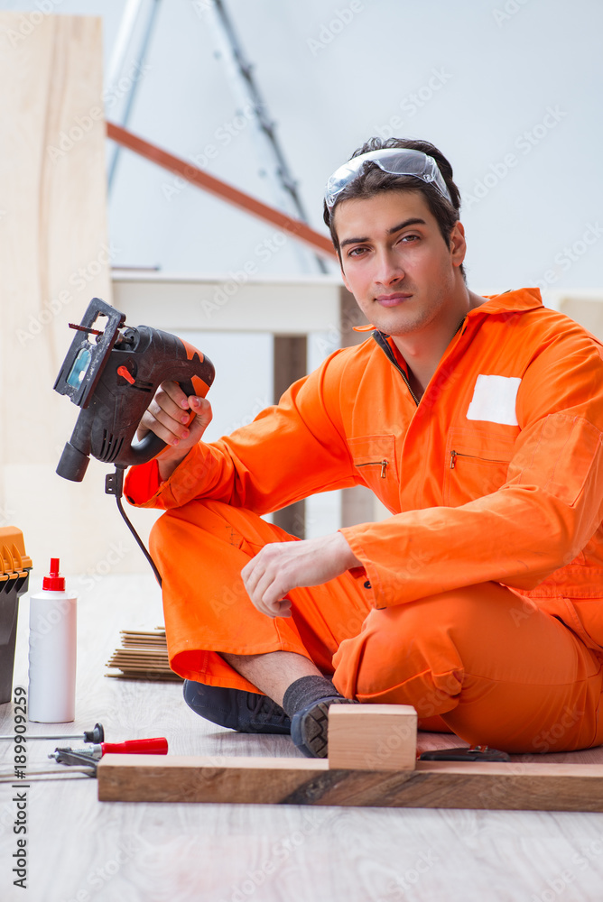 Contractor working on laminate wooden floor Contractor working on laminate wooden floor